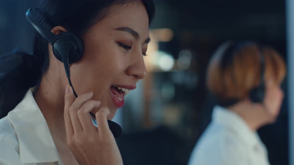 Asia young call center team or customer support service executive using computer and microphone. alt