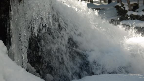 Frozen Icicle Hanging By Raging Mountain Waterfall Slow Motion Gimbal Movement alt