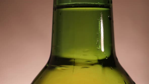 Macro Shot of Beer Bottle with Water Drop and Camera Movement alt