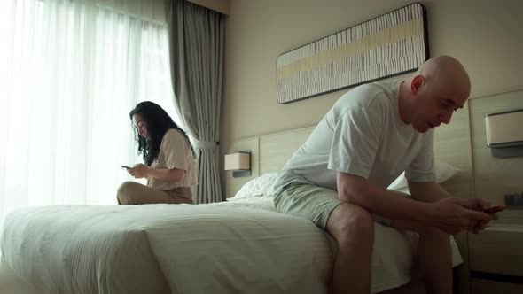 Worried Couple is Upset Woman and Man Feel Offended Frustrated By Quarrel Couple Using Their Phones alt