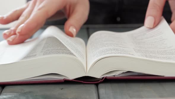 Close Up of Female Hands Turning Pages of a Book alt