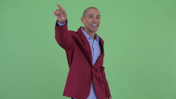 Happy Bald Multi Ethnic Businessman Pointing Finger alt