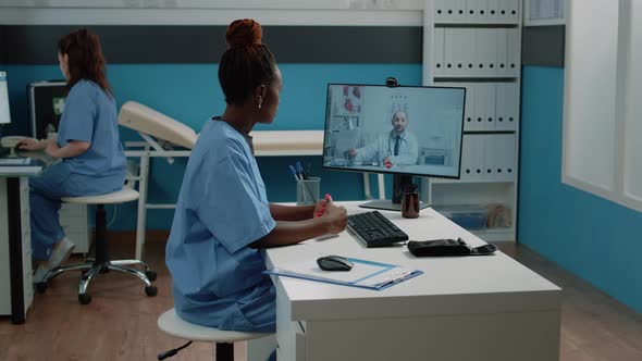 Nurse Talking to Doctor on Video Call Connection in Cabinet alt