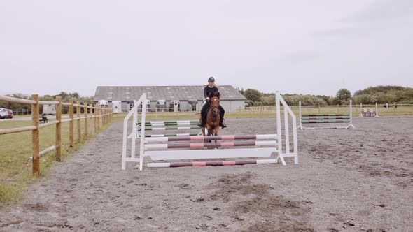 Young Woman On Horseback In Paddock alt