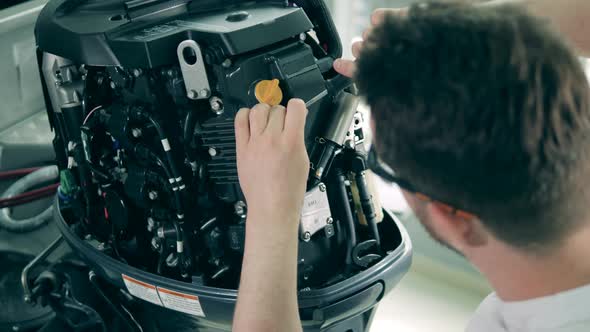 Boat's Engine Is Getting Dismantled By a Serviceman alt