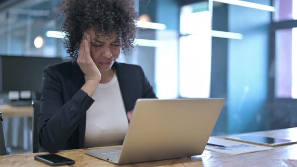 Tired African Businesswoman Having Headache at Work alt