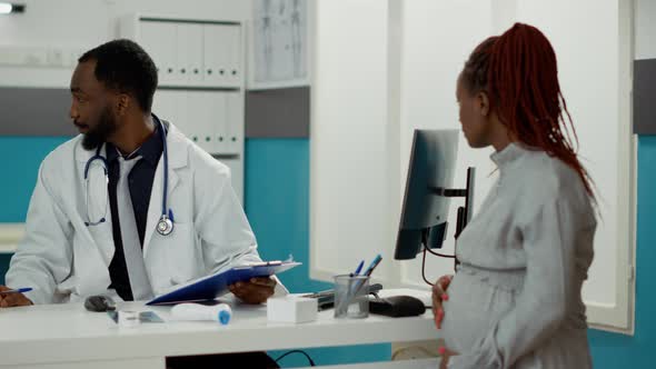 General Practitioner Explaining Prescription Treatment in Bottle alt