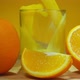 Fresh Sweet Orange Juice is Poured in a Glass Next to Ripe Oranges