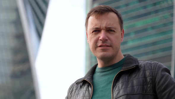 Serious Upset Man in Black Jacket Showing x Sign Crossed Arms Portrait on Urban Cityscape alt