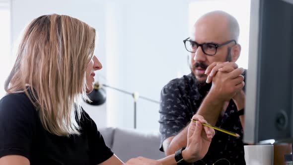 Blond Modern Woman And Bald Men Chatting In An Office