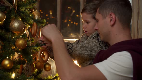Father and Son Decorate the Christmas Tree alt