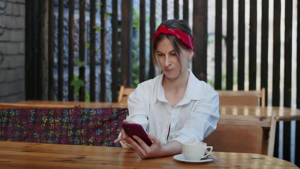 Happy Girl Talking on Video Call Via Phone or Watching Video in Street Cafe Easy Lifestyle and alt