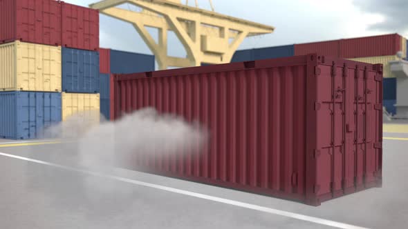 The red container falls with clouds of dust