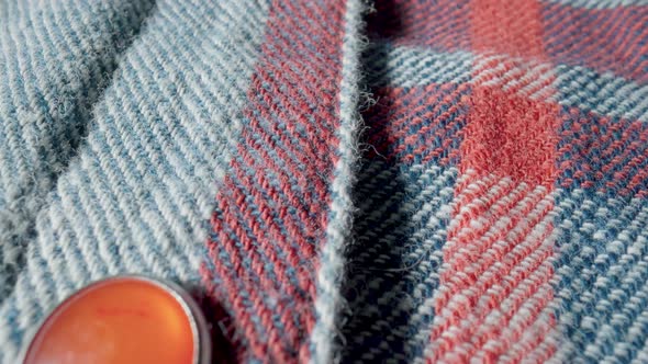 Background From a Warm Woolen Plaid Shirt with Red Buttons in Macro alt