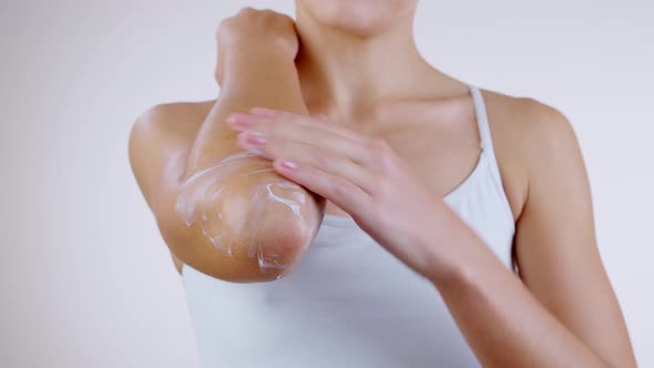 Woman Caring for Her Dry Elbow