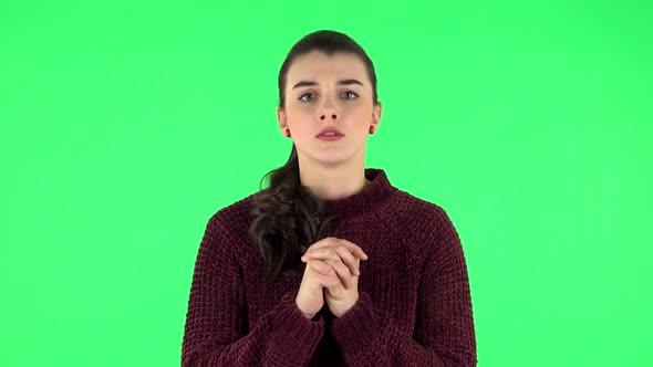 Woman Looking at Camera with Anticipation, Then Very Upset. Green Screen alt