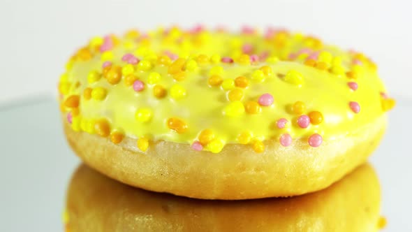 Rotating Donuts with Different Fillings on the Mirror Table. Delicious Sweet Donut Rotating alt