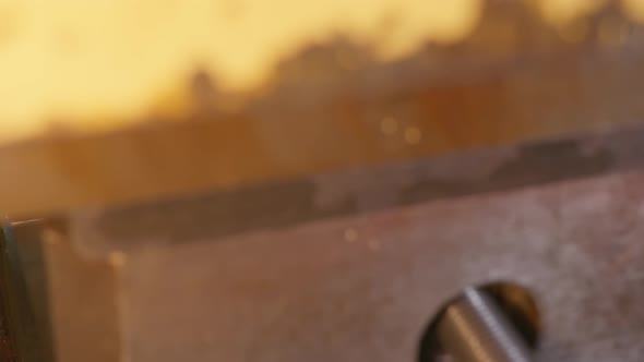 Close Up at the Machinetool Making a Silver Spoon and Then the Hand of the Worker Takes the Finished alt