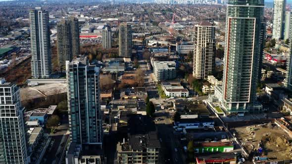 High-rise Buildings In Burnaby With Downtown Vancouver In The Background In Canada. - aerial pullbac alt