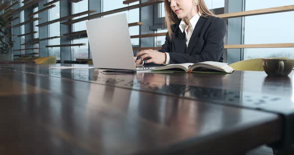 Concerned Woman Working on Laptop Computer and Looking Away Thinking Solving Problem at Office alt