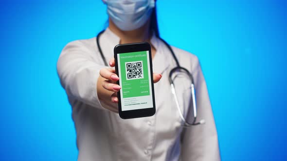 Woman Doctor in Medical Uniform Showing Vaccination Passport with Qr Code on Phone International alt