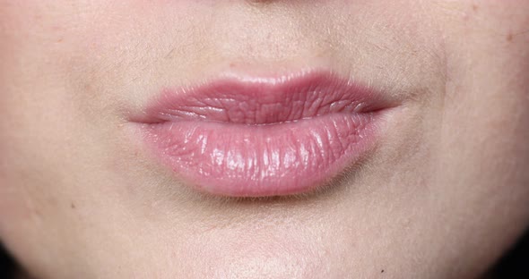 Woman's Lips Kissing in Close-up