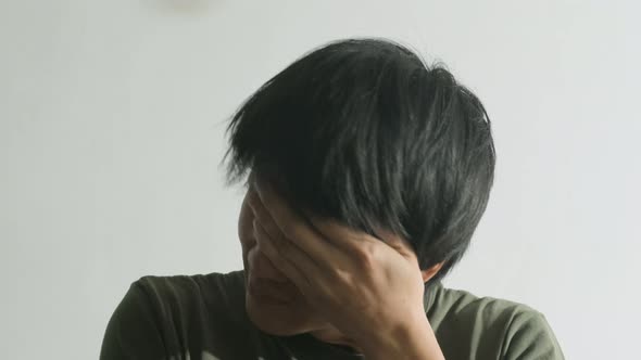 Asian unhappy man unemployed worker sitting on chair feeling stress and unhappy that have no job. alt