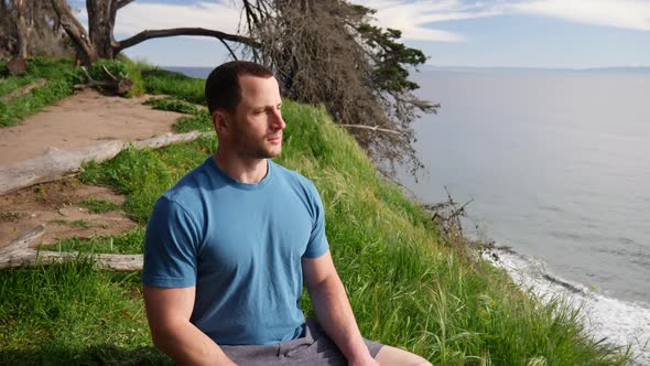 A man sitting in a meditation pose after a workout to practice mindfulness and stress relief on a be alt