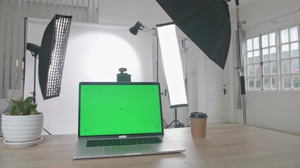 Photo Studio With Professional Equipment And Green Screen Laptop Computer Display alt