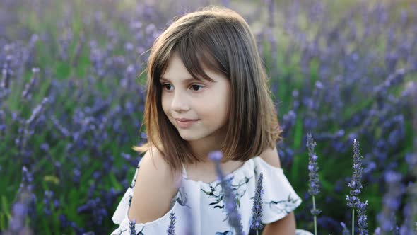 Face of Beautiful Little Girl With Lavender Field at Sunset