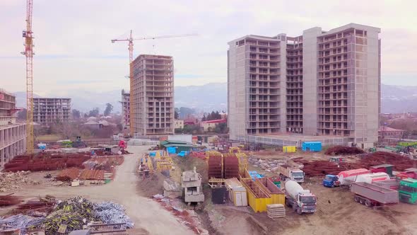 Drone view of construction of multi-storey buildings background of mountains. alt