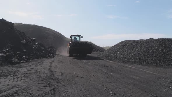The Loader Carries Coal in the Bucket, About To Load It Into the Truck