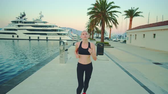 Fit Woman Jogging in the Morning in the Sea Port