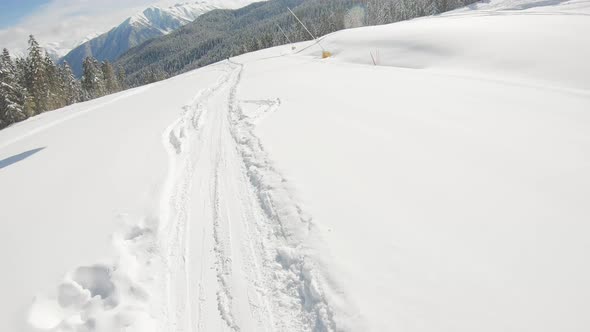 Firstperson View Snowboarder on Snowboard Running Down the Slope in Ski Resort alt