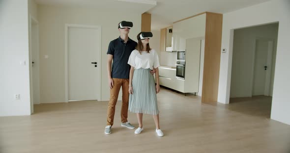 Couple Viewing New Apartment With VR Headsets