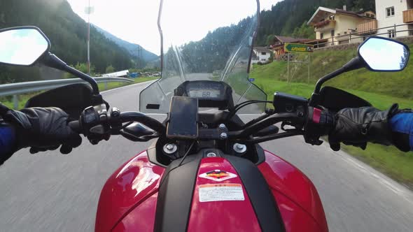 POV of Biker Rides a Motorcycle on a Scenic Mountain Road in Austria alt
