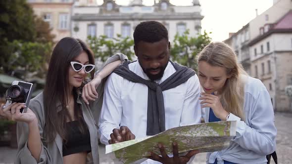 Mixed Races People Standing in the Street and Looking at Map alt