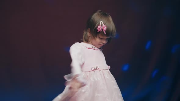 Cute Little Girl in Vintage Pink Dress is Spinning in Dance and Rejoicing