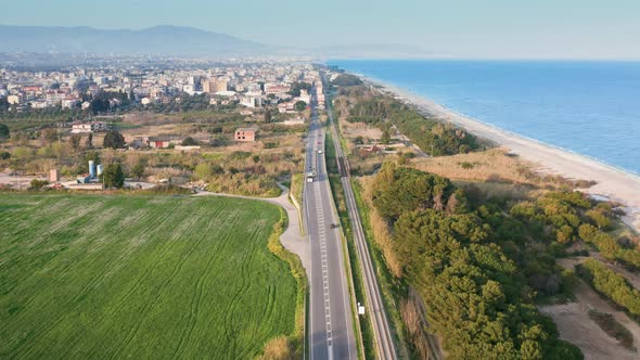 Road with Little Traffic for Access to a Small Village Near the Sea with Beach alt