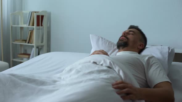 Man in Bed Seeing Nightmares While Asleep, Former Soldier Dreaming About War alt