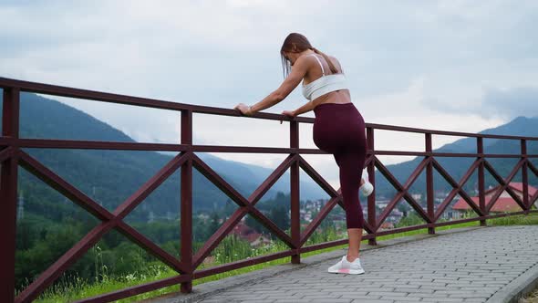 Slender Woman is Doing Sport Caring About Her Health and Beauty Training Legs for Slimness alt