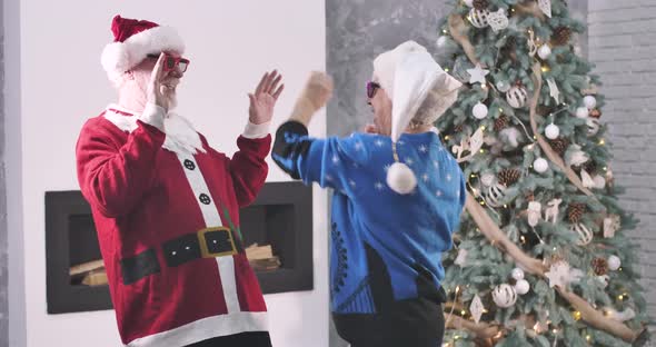 Positive Senior Caucasian Man and Woman Playing Clapping Game and Starting Fun Dancing alt