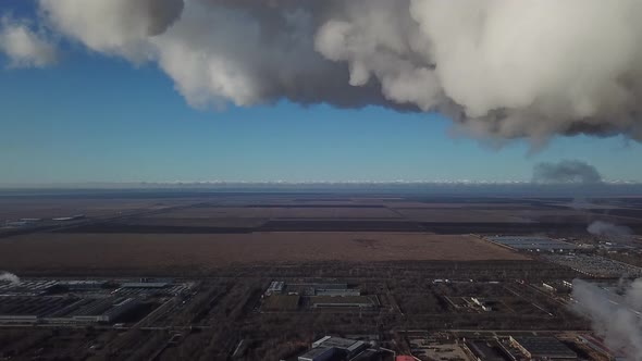 Thick White Smoke of Factory Chimney Obscures the Clear Blue Sky alt