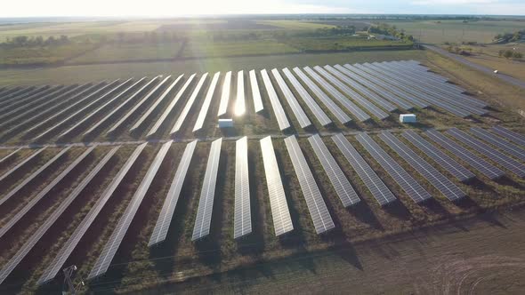 Aerial Shot of a Solar Power Station with Lense Panels in Ukraine at Sunset  