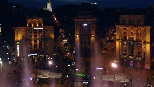 Aerial View of Night City with Colored Splashing Fountains alt