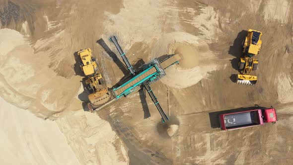 Aerial view loading bulldozer in open air quarry. Sand mining industry. Bulldozer machine. Crawler b alt
