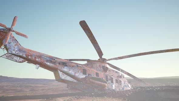 Old Rusted Military Helicopter in the Desert at Sunset alt