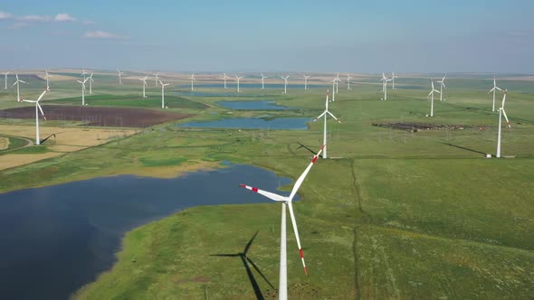 Aerial View of Windmills on Wind Farm in Rotation alt