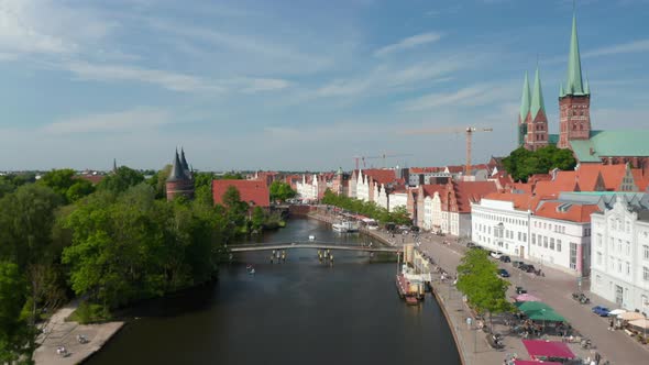 Forwards Fly Above Trave River Flowing Around Medieval Historic City Centre alt