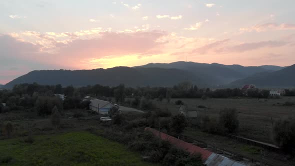 Scenic View of Mountain Village at Sunset Sky alt